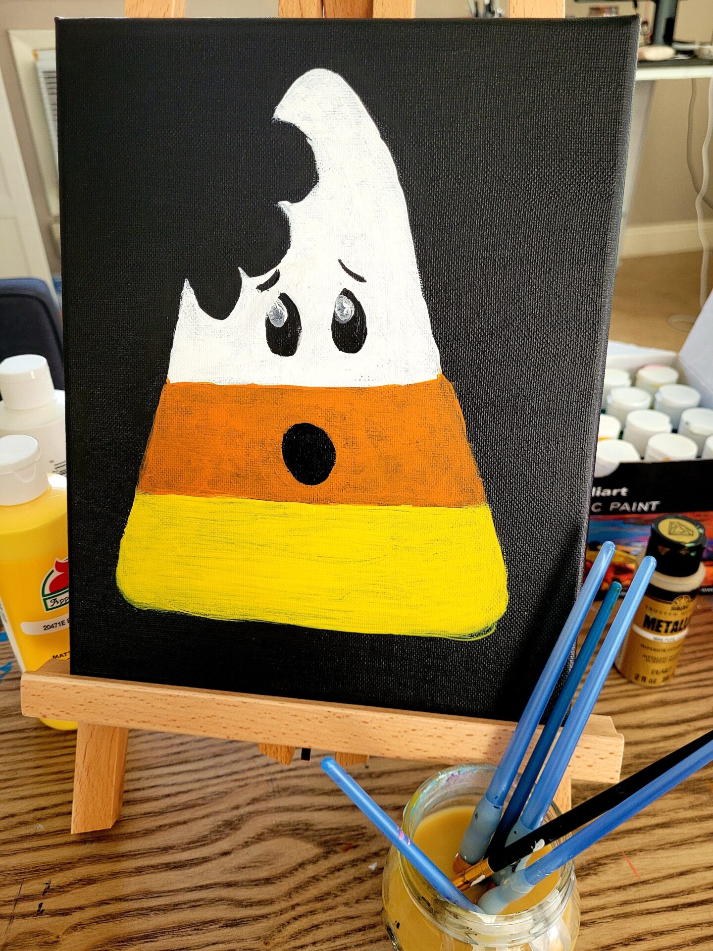 A Bitten Candy Corn Painting in Black Background