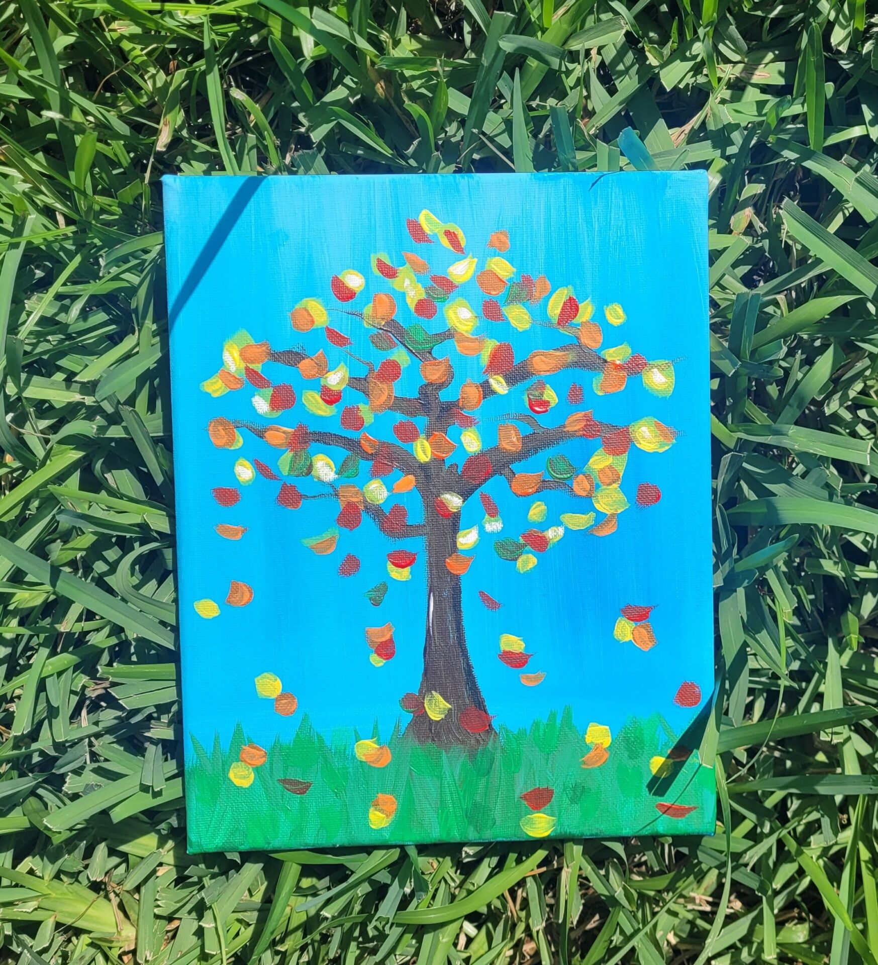 A Fall Theme Painting on a Canvas on Grass